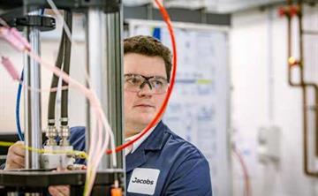 Jacobs employee using testing equipment at the High Temperature Testing Facility at Birchwood Park.