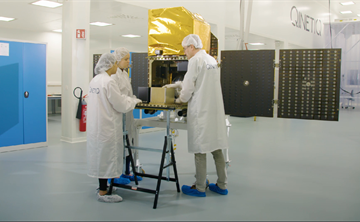 Engineers assembling space hardware in the cleanroom.